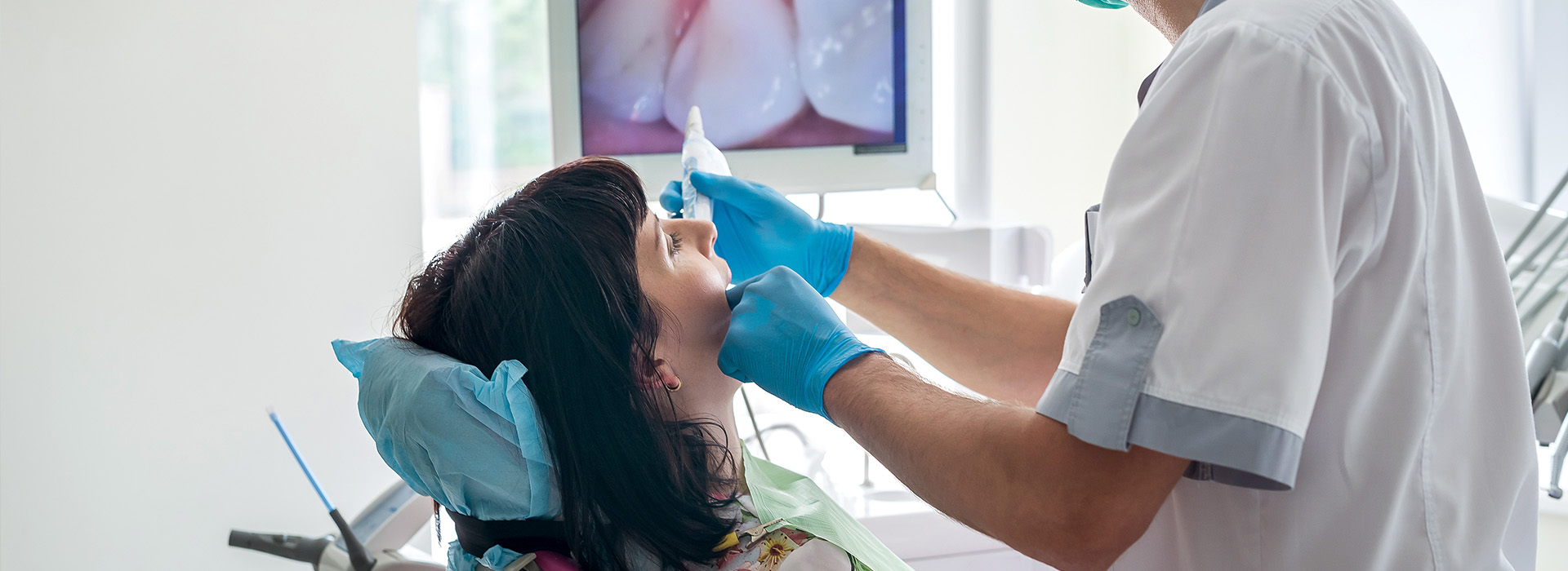 Dental professional assisting patient with dental treatment.